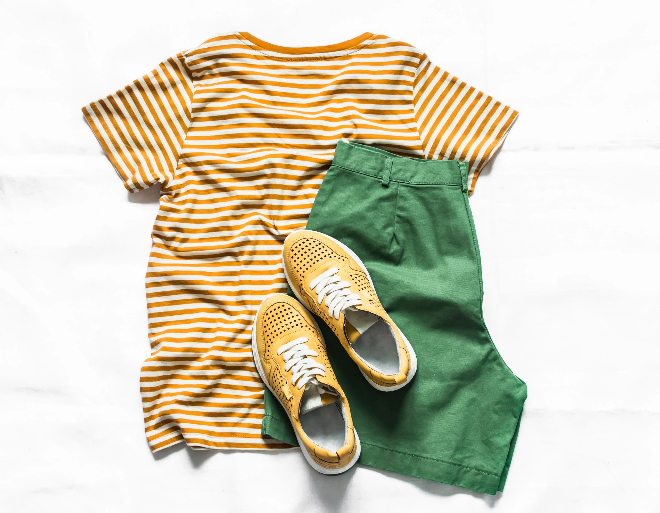 T-shirt and sneakers flat lay fashion concept