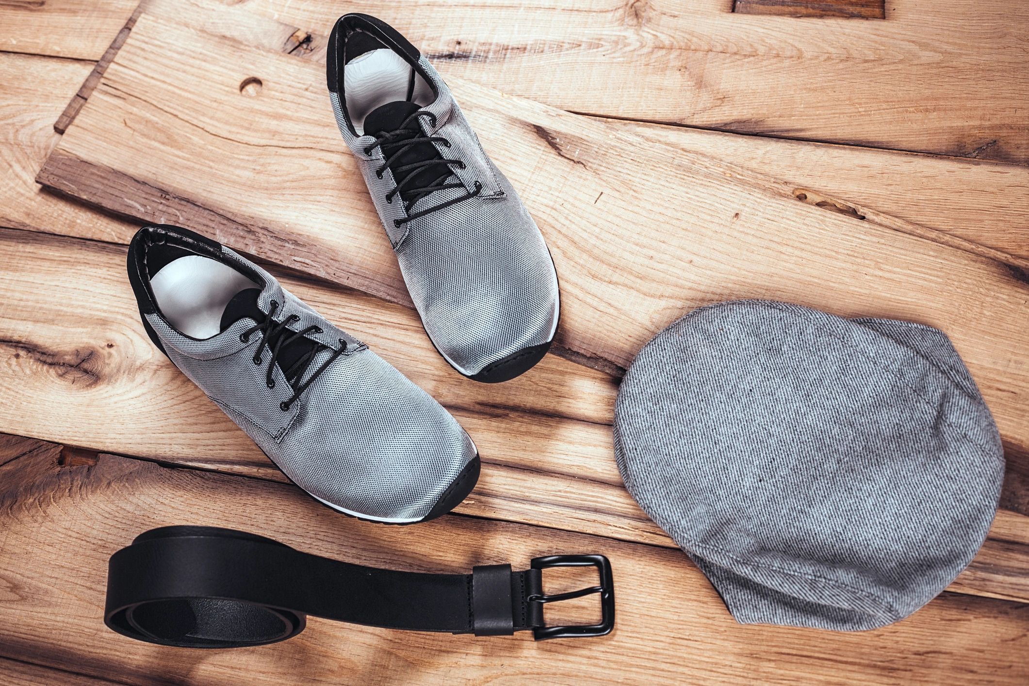 Men's accessories organized on a wooden table
